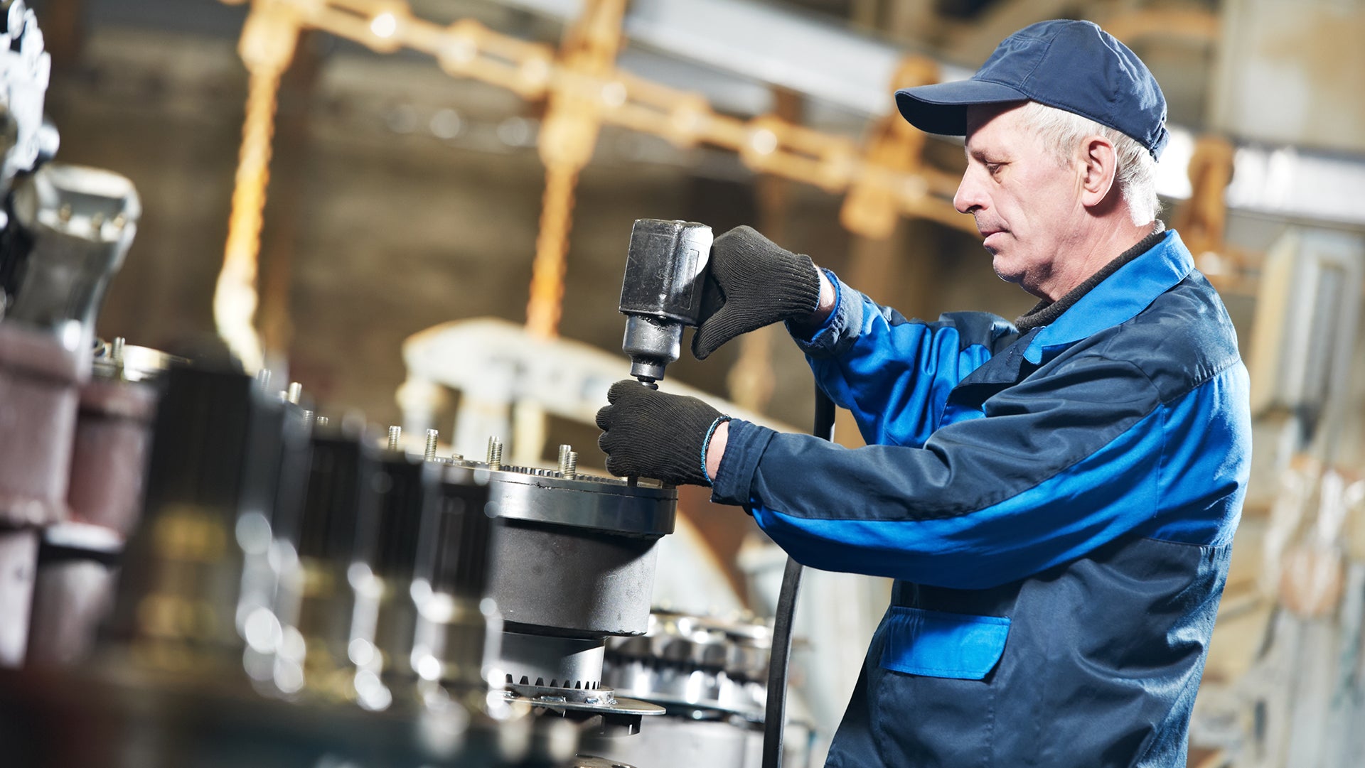 Old man using Wrench